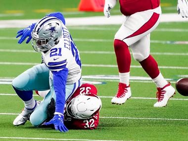 Dallas Cowboys running back Ezekiel Elliott (21) fumbles on a hit from Arizona Cardinals strong safety Budda Baker (32) during the first quarter of an NFL football game at AT&T Stadium on Monday, Oct. 19, 2020, in Arlington. The Cardinals recovered the fumble.