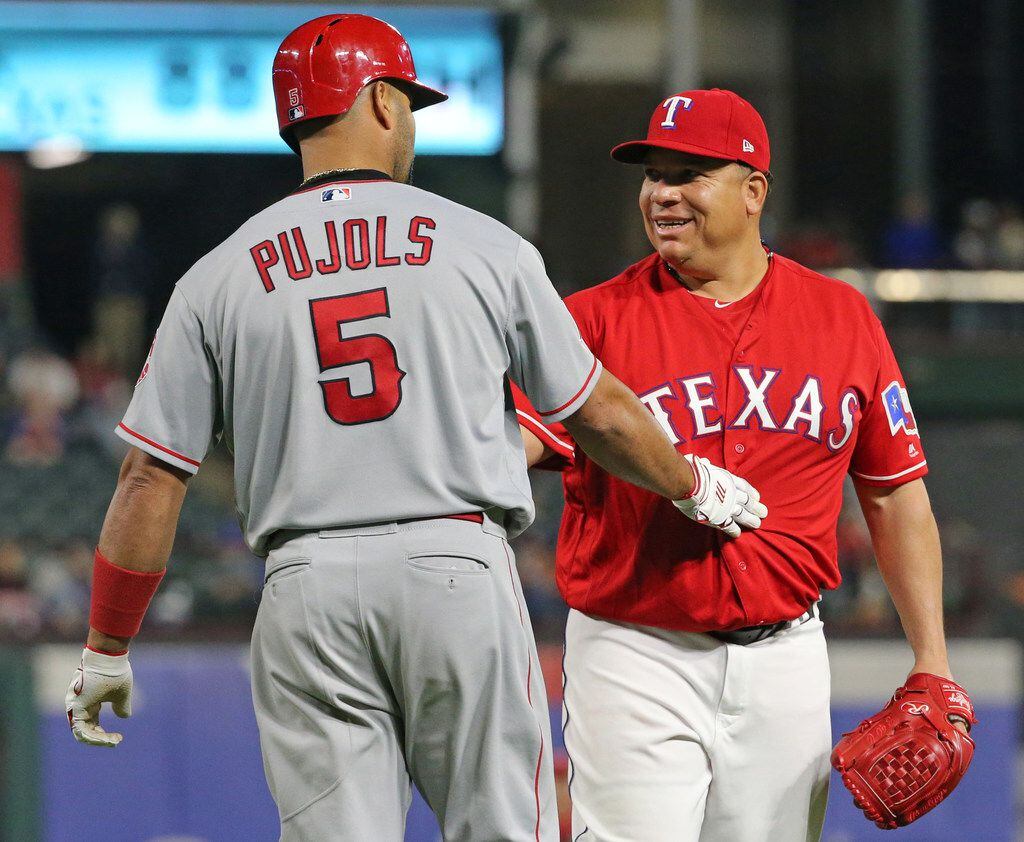 Los Angeles Angels designated hitter Albert Pujols (5) checks with Texas Rangers pitcher...