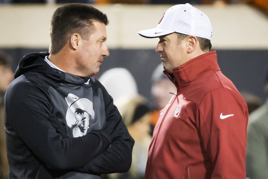 Oklahoma State head coach Mike Gundy (left) chats with Oklahoma head coach Bob Stoops before...