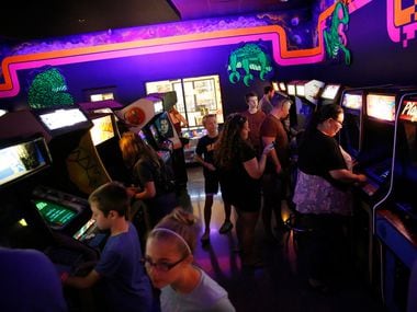 People play video games at the National Videogame Museum in Frisco on Aug. 2, 2018. (Rose Baca/The Dallas Morning News)