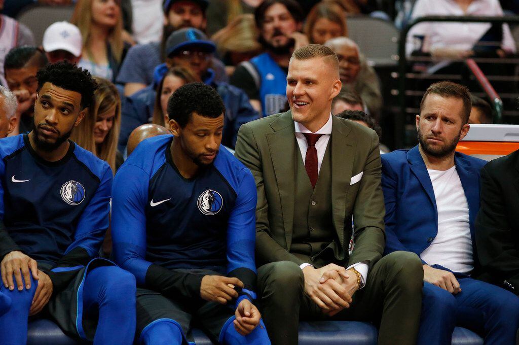 Dallas Mavericks forward Kristaps Porzingis (6) laughs from the bench during the first half...