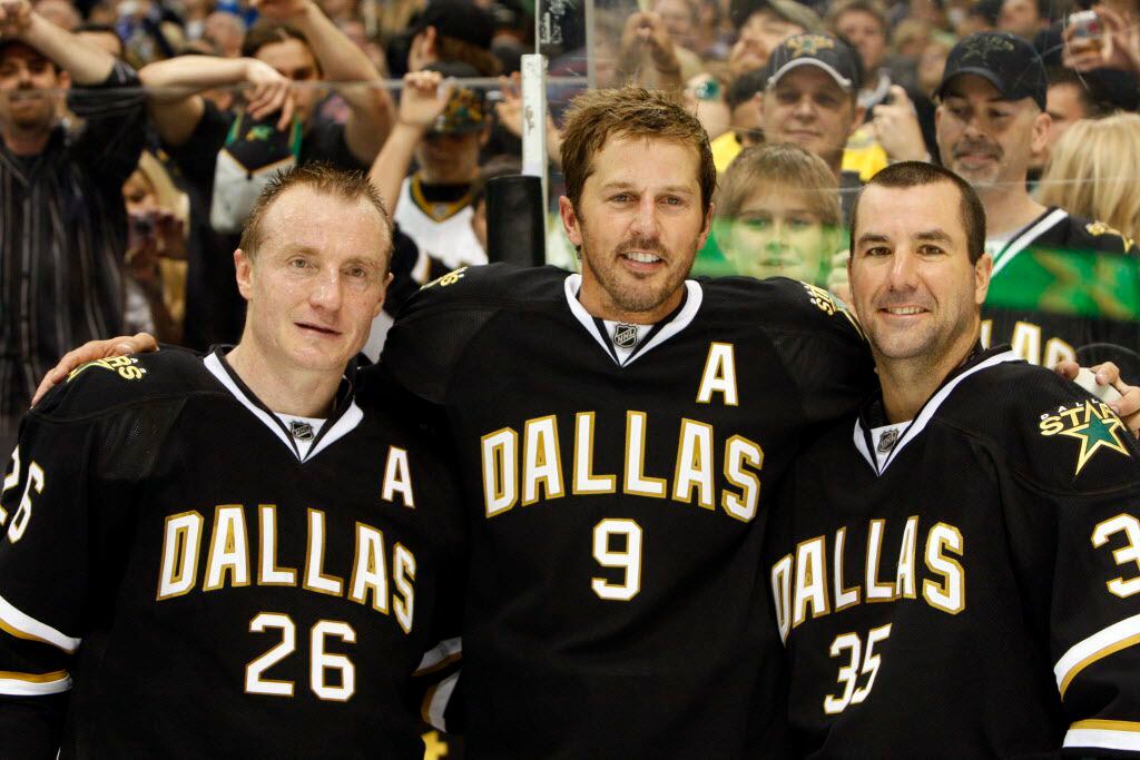 Dallas Stars Jere Lehtinen (26), Mike Modano (9) and Marty Turco (35) pose after the last...