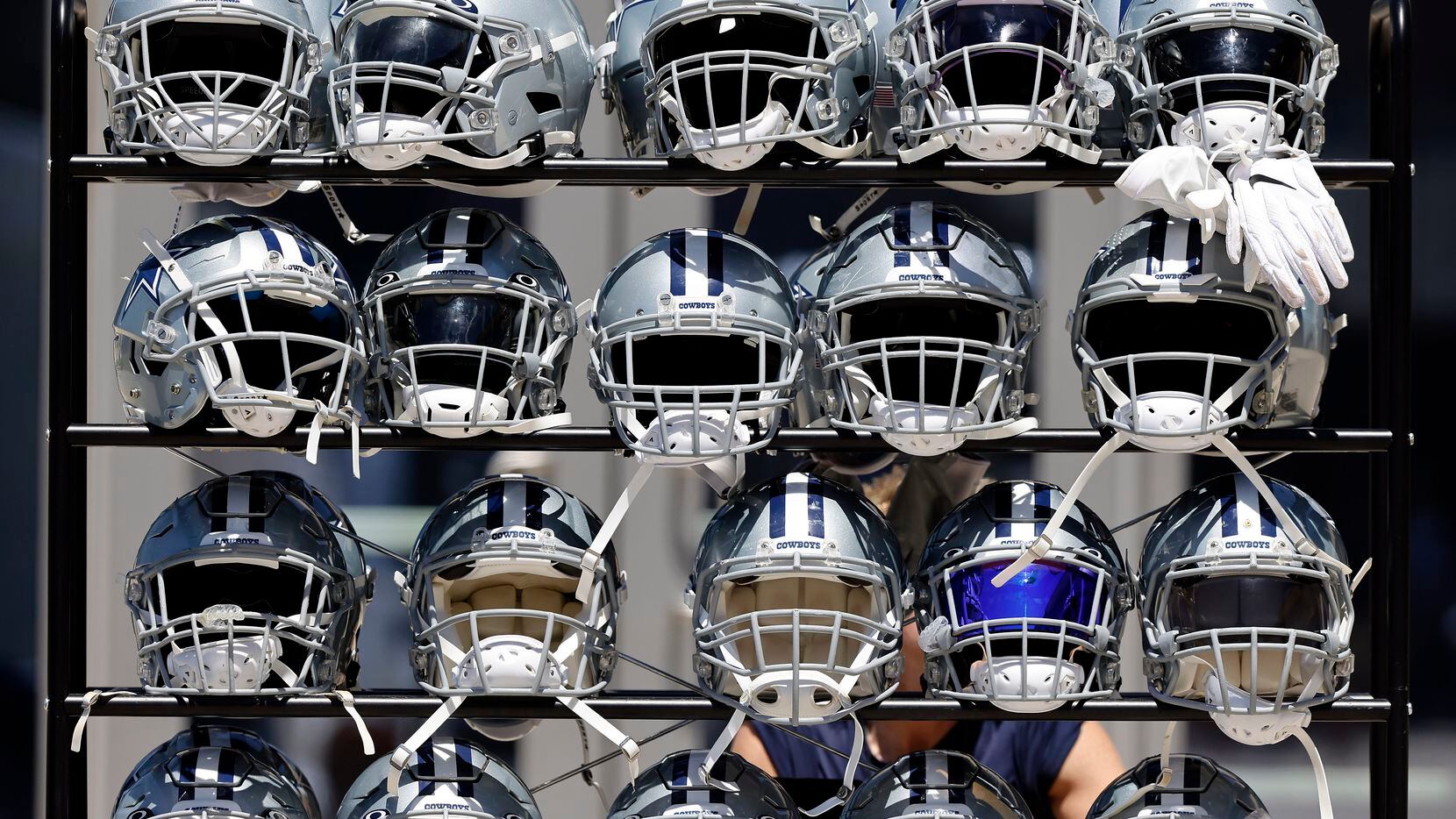 A rack of helmets are pictured following Training Camp practice at The Star in Frisco, Texas, Tuesday, August 24, 2021.