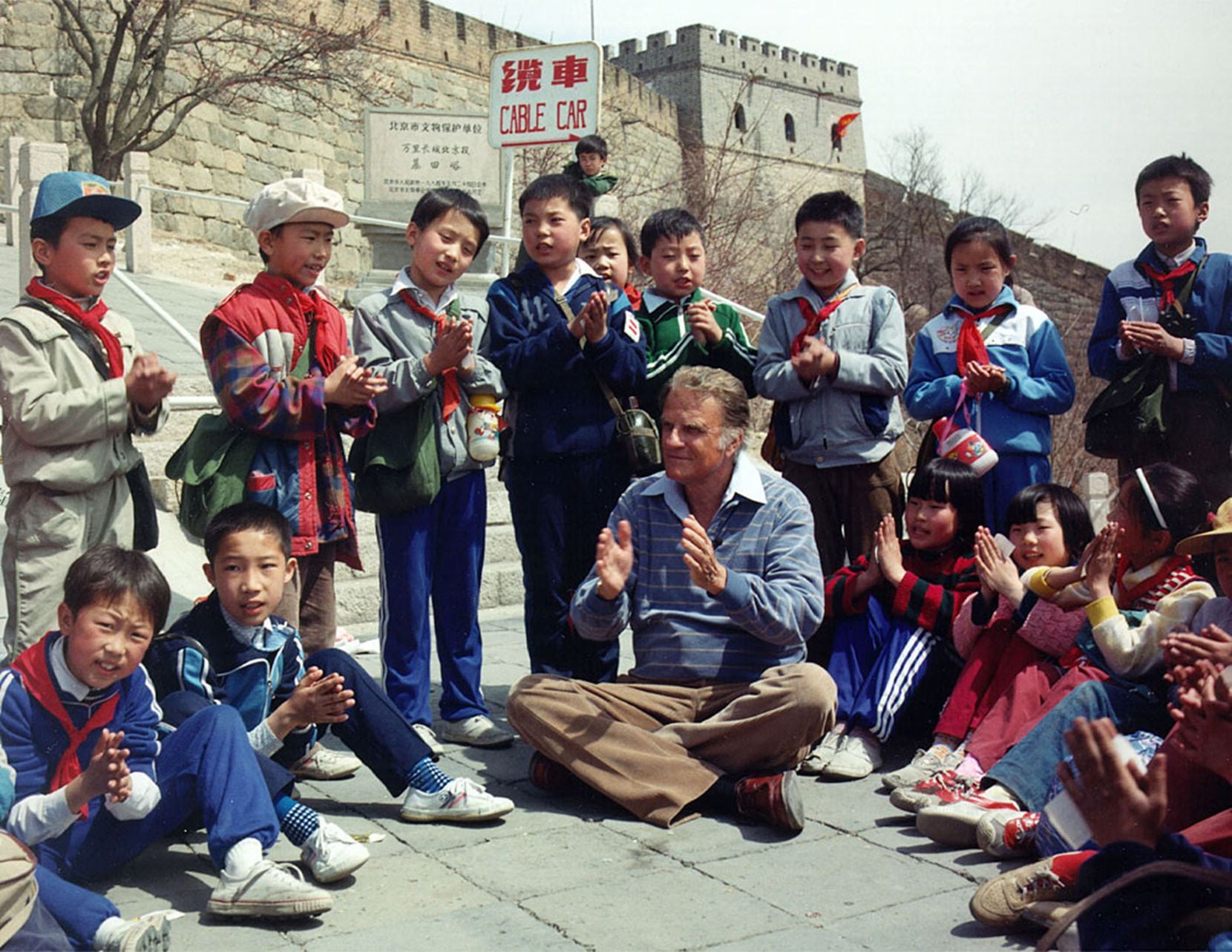 Billy Graham shares fellowship with children during his 17-day tour of China in 1988. 