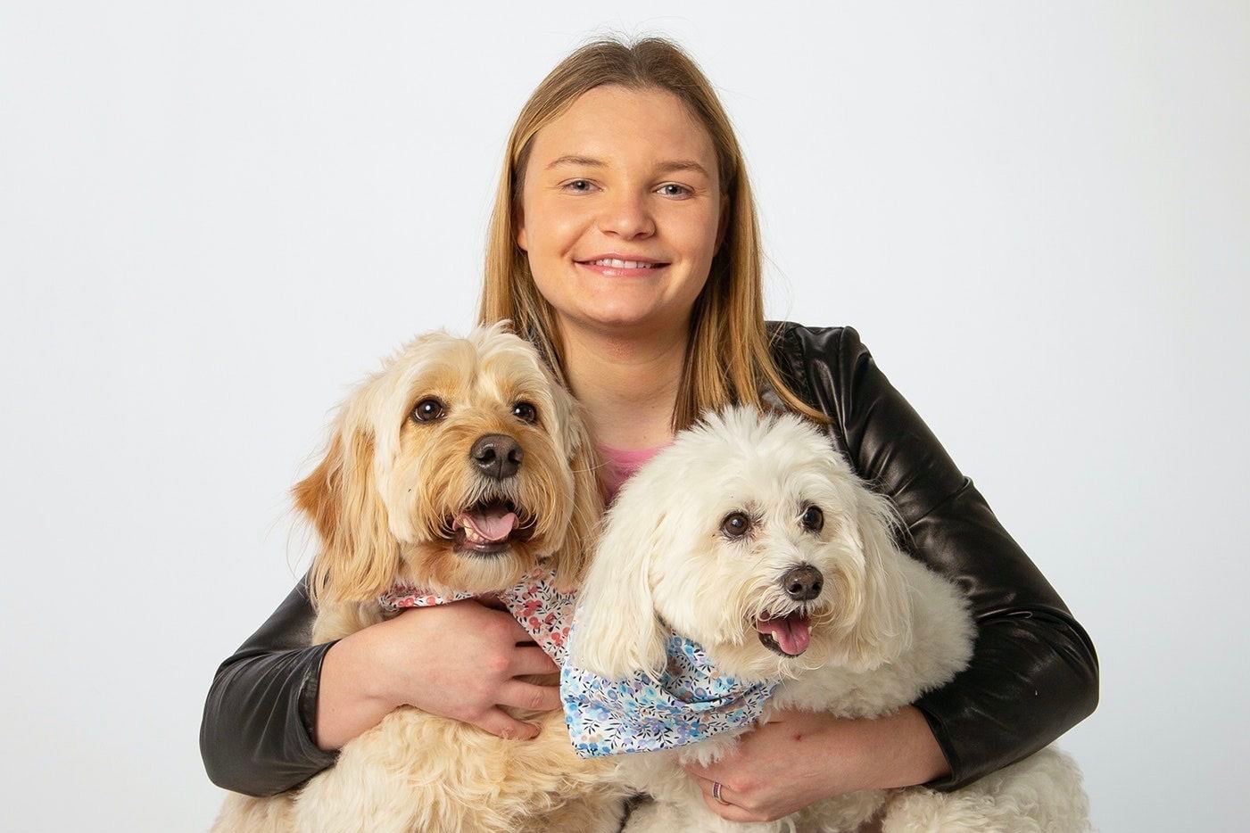 Gracie Dix, an 18-year-old author from Dallas, snuggles her dogs Sandy and Snowball....