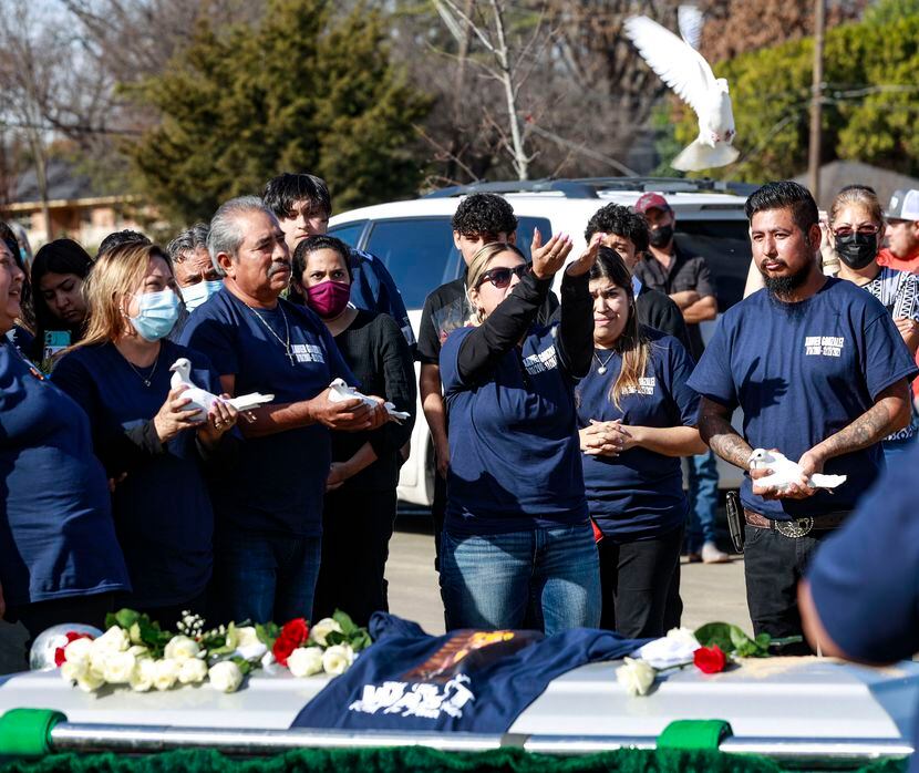 Lluneli Lopez releases a dove at a funeral for her son Xavier Gonzalez at Garland Memorial...