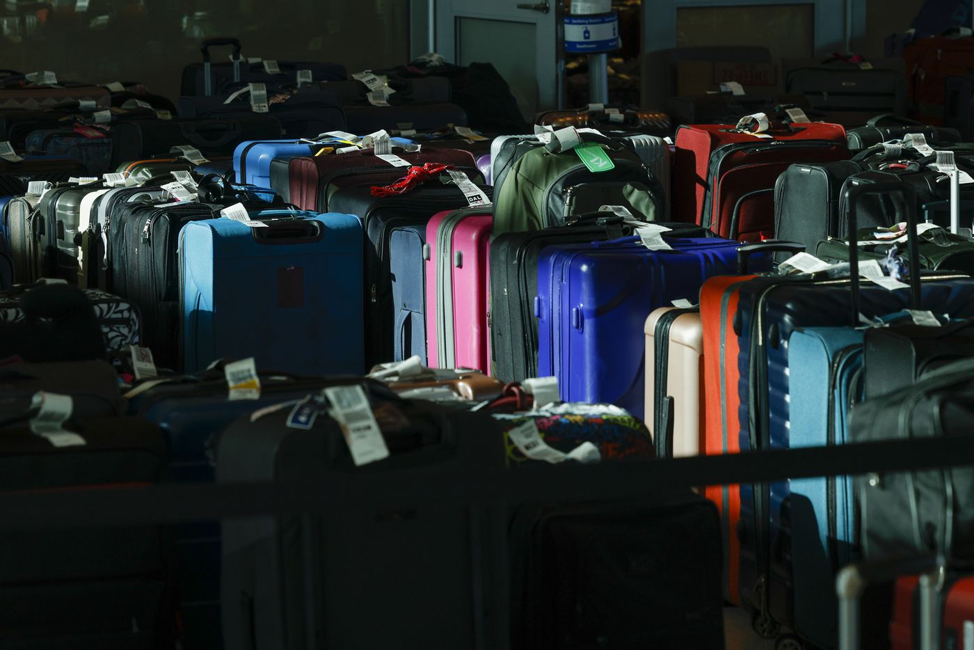 Dozens of checked bags sit outside the Southwest Airlines baggage service office on Wednesday.