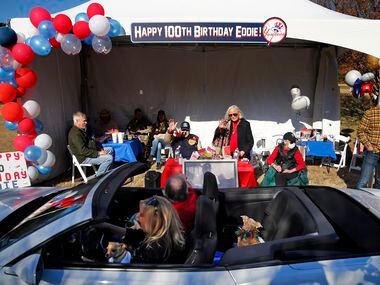 Eddie Robinson (seated), the oldest living former MLB player, waves to friends who delivery...