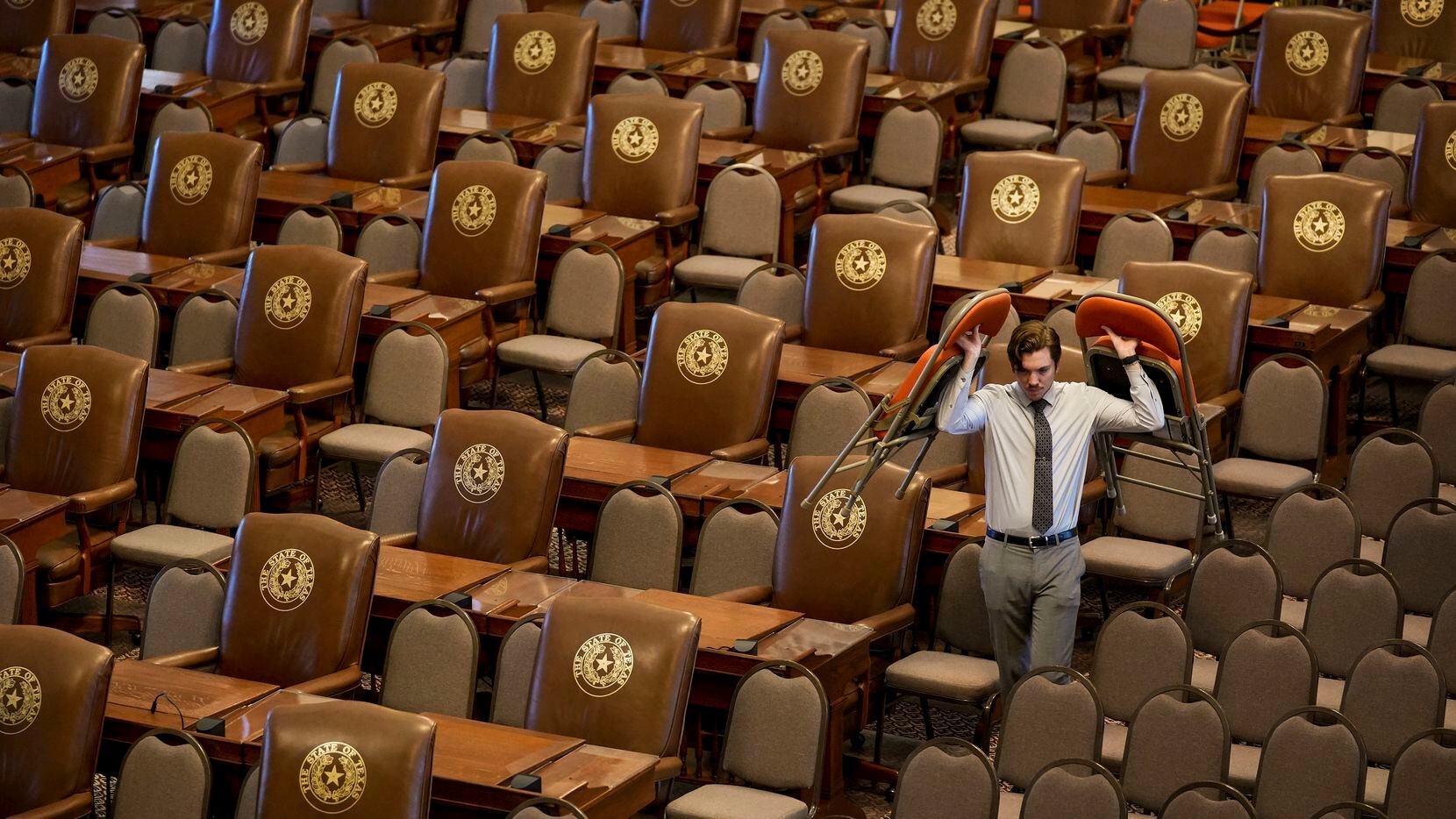 Devan Petersen, a supervisor with the Office of the Sergeant at Arms, sets up temporary...