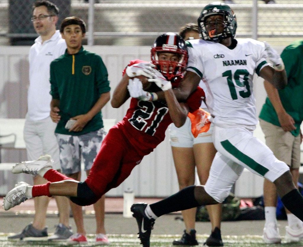 North Garland defender Isaiah Watkins (21) makes an interception in front of Naaman Forest's Bryson Huey (19) during the first half of their high school football game at Williams Stadium in Garland on Friday, October 4, 2019. (John F. Rhodes / Special Contributor)