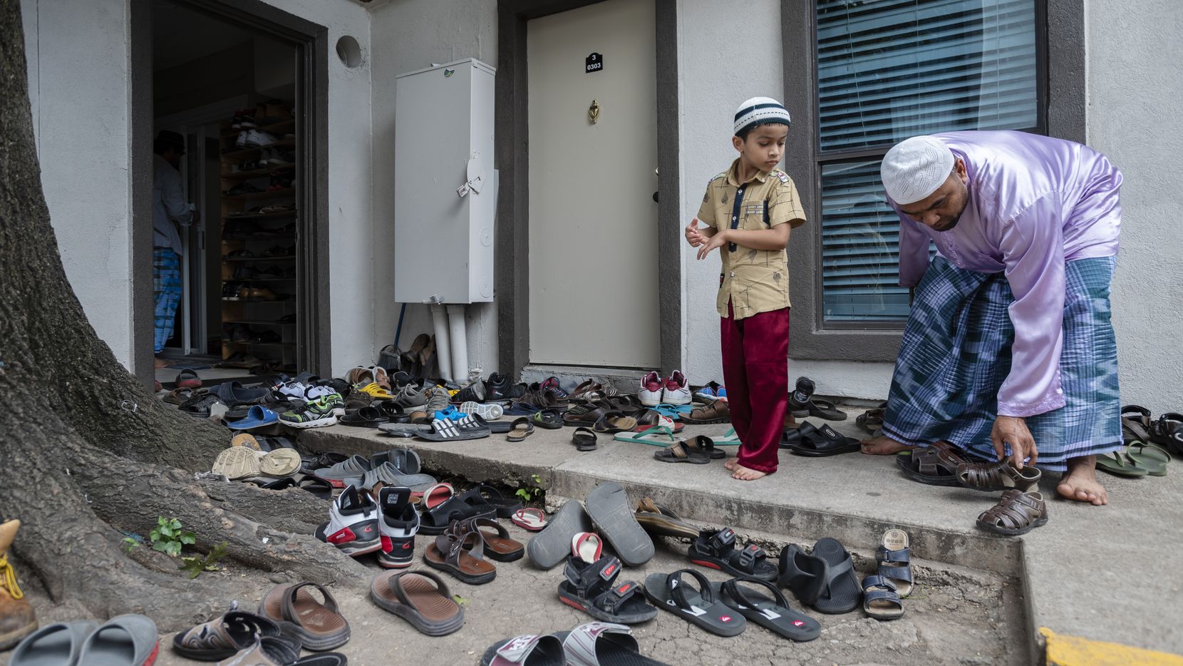 Rohingya refugees remove their shoes before entering a mosque inside an apartment complex in Dallas.