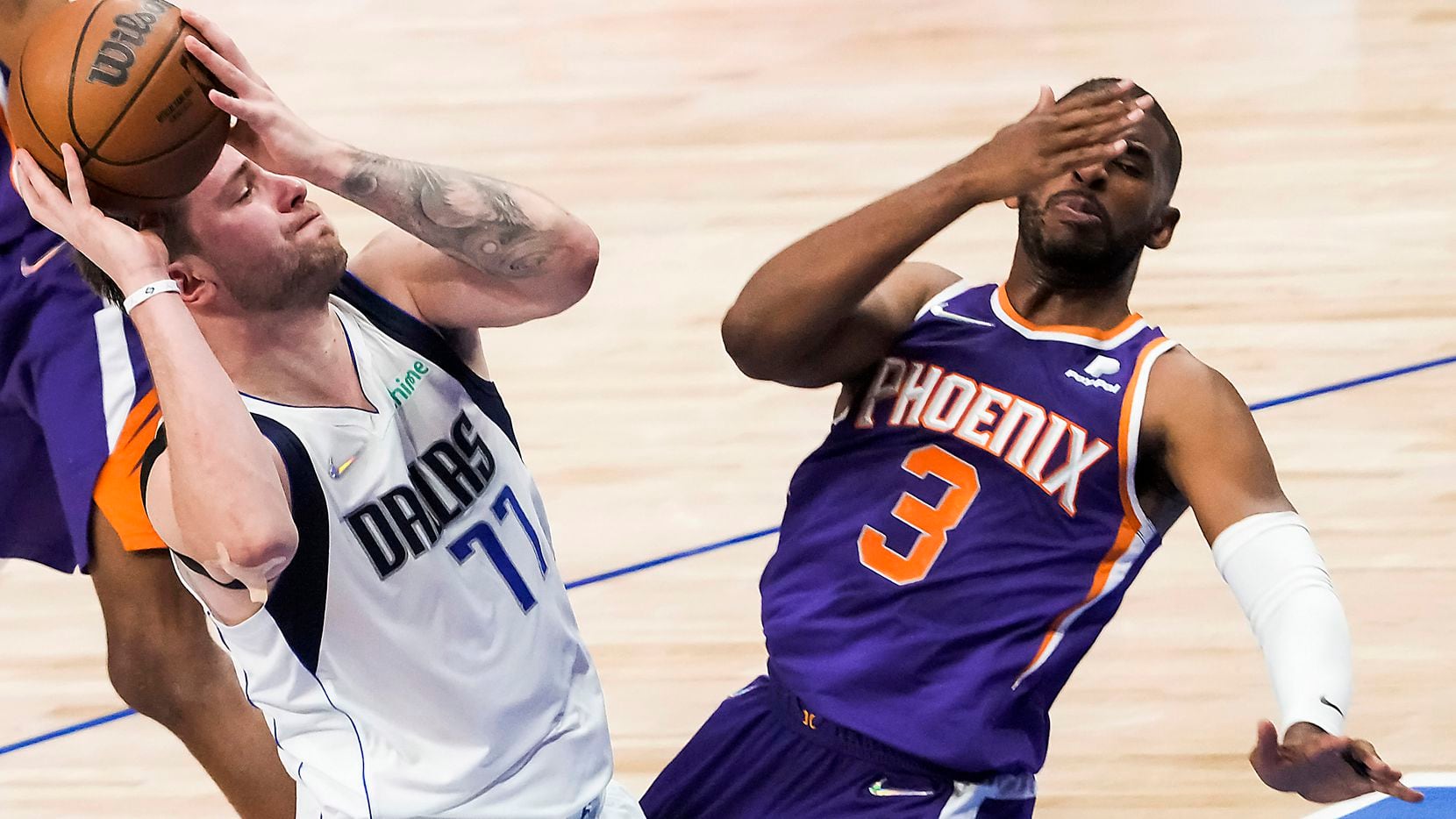 Phoenix Suns guard Chris Paul (3) falls backwards as he is fouled by Dallas Mavericks guard...