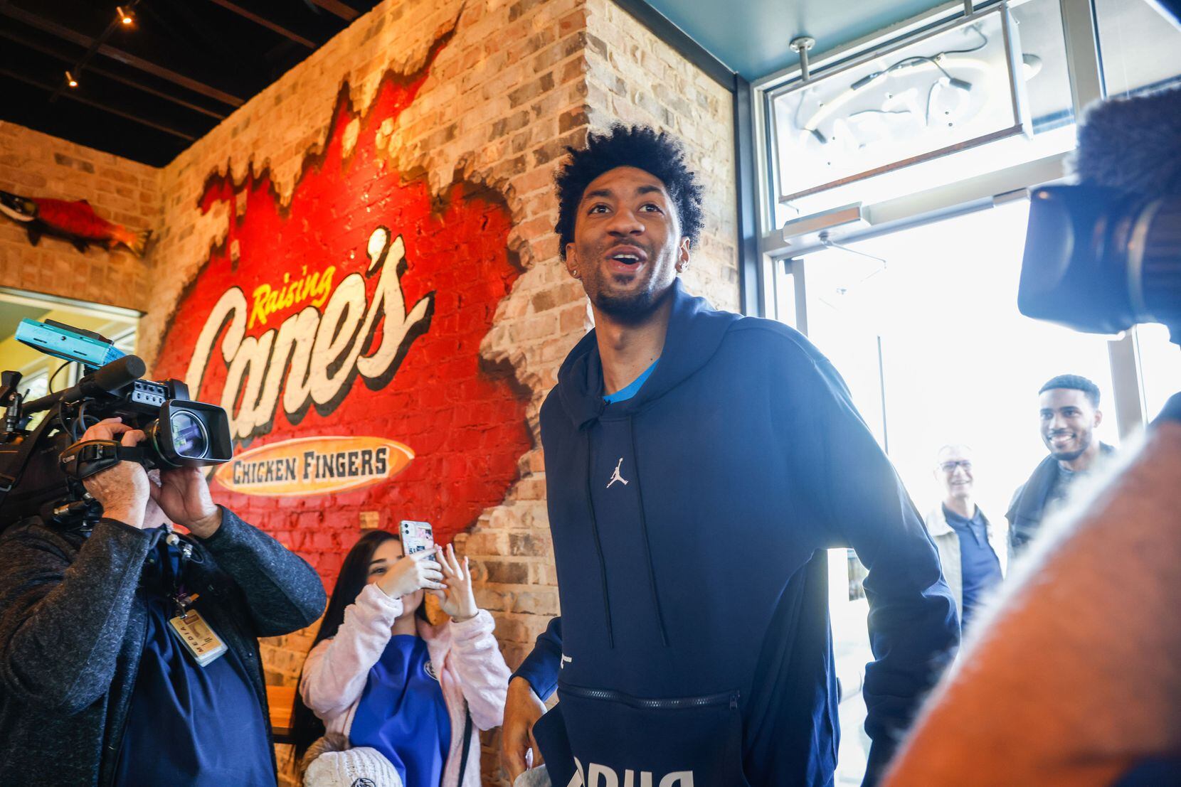 Mavericks player Christian Wood arrives to serve lunch at the Raising Cane’s in Dallas on...