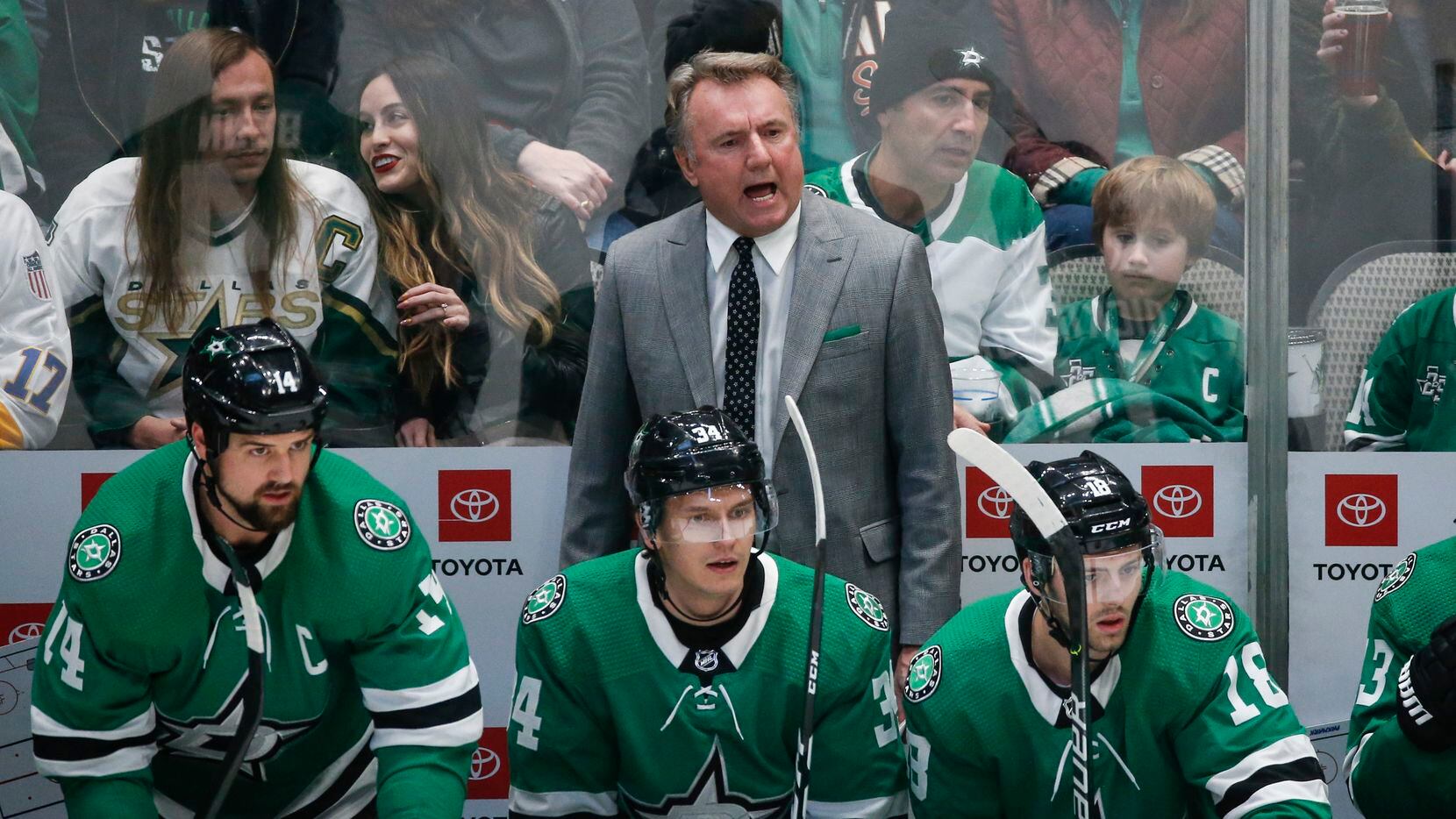 Dallas Stars interim head coach Rick Bowness works the bench during the first period of a...