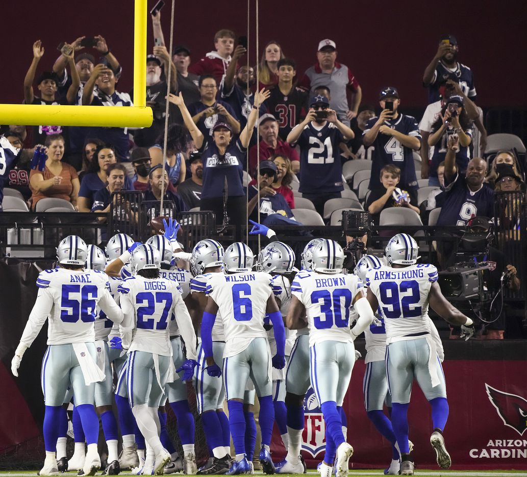 Dallas Cowboys fans cheer as the defense celebrates a fumble recovery by linebacker Keanu Neal (42) during the first quarter of an NFL football game against the Arizona Cardinals at State Farm Stadium on Friday, Aug. 13, 2021, in Glendale, Ariz.