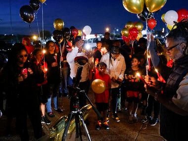 Preston Malone II says a prayer before a balloon release in memory of 11-year-old De’Evan...