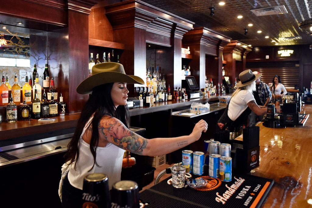 Bartender Carly Campbell tends to the bar before the opening of Mama Tried, the new...