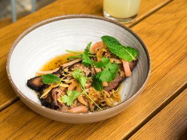 Smoked beef brisket with chili gastrique and Thai herbs is one of the more popular dishes at Loro. It shows off the flavor play between pitmaster Aaron Franklin, of Franklin Barbecue, and chef Tyson Cole, of Japanese restaurant Uchi.