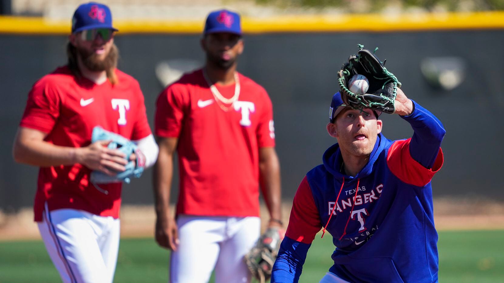 Texas Rangers infielder Brad Miller makes a catch on a chopper at third base during a spring...