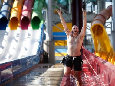 Tyler Hebert celebrates after going down a water slide during a media day at the new Epic Waters Indoor Waterpark in Grand Prairie, Texas on Monday, Jan. 8, 2018. The city-owned waterpark is the largest in North America under a single retractable roof. 
