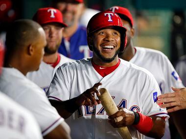 Texas Rangers shortstop Elvis Andrus (1) smiles big as he is congratulated by teammates...
