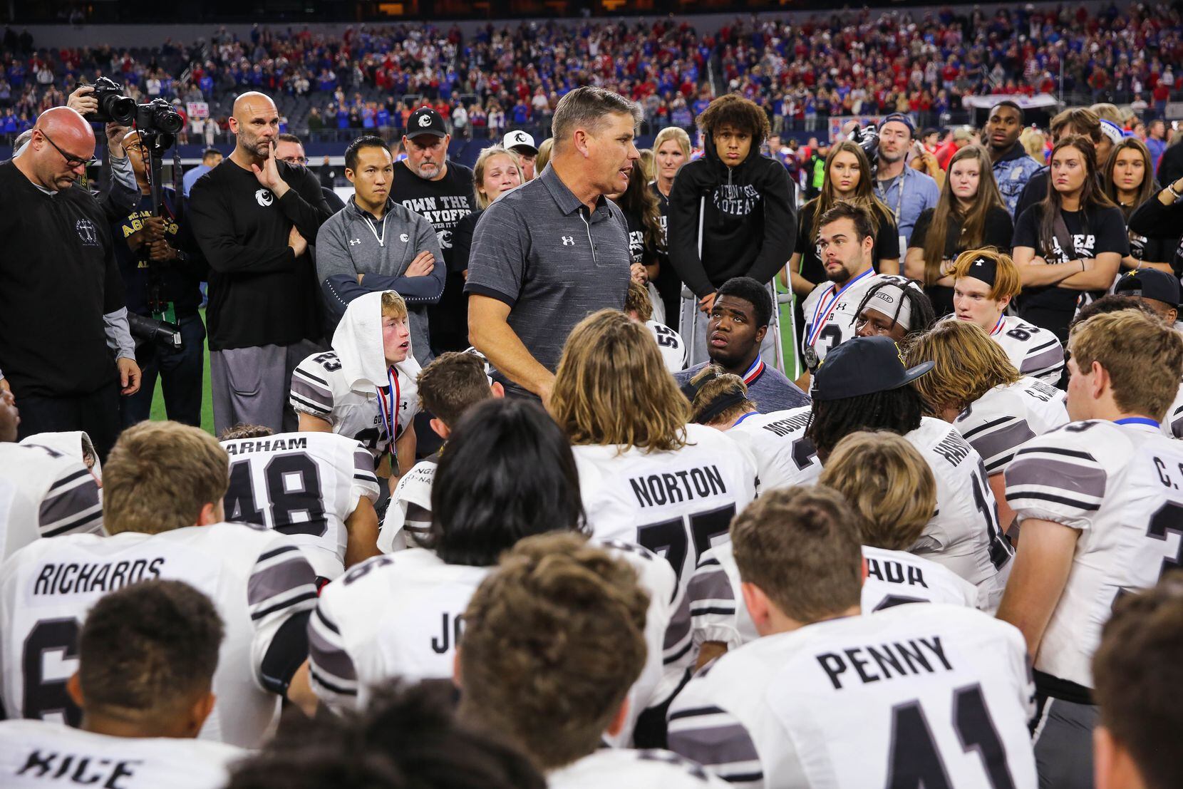 Denton Guyer's coach John Walsh talks to his team after losing a Class 6A Division II state...