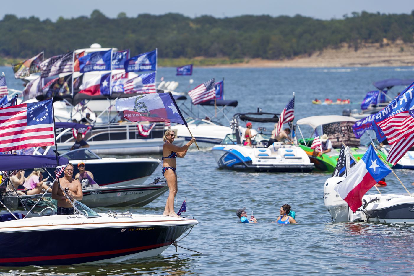 Supporters of President Donald Trump attend a campaign rally and boat parade at Oak Grove Park on Grapevine Lake on Saturday, Aug. 15, 2020.