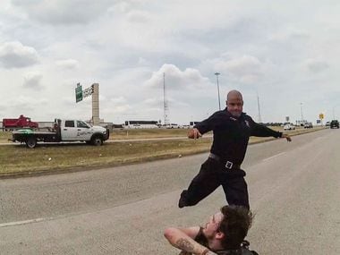 A frame from a police body cam showing  Dallas firefighter Brad Cox during an altercation with Kyle Robert Vess on August 2, 2019.