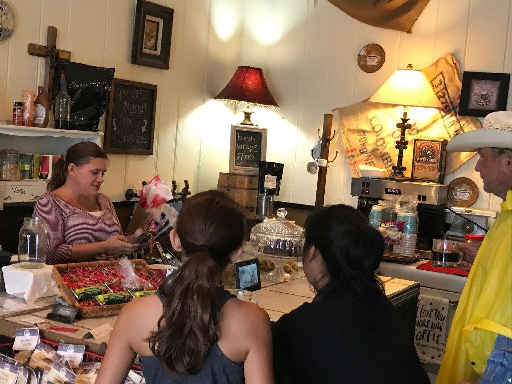Customers gather at The Shop Downtown in Schulenburg, Texas where Christina Heindrich, left,...