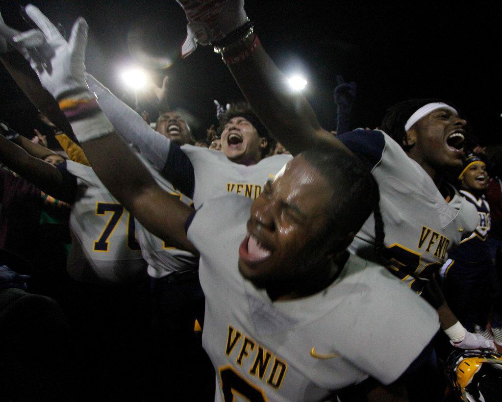 Arlington Lamar linebacker Jayveion Moore (9), center, lets out a yell as he celebrates with...