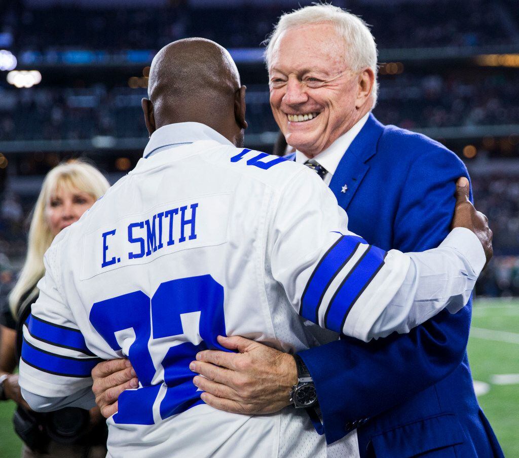 Dallas Cowboys owner Jerry Jones gets a hug from former Dallas Cowboys running back Emmitt...