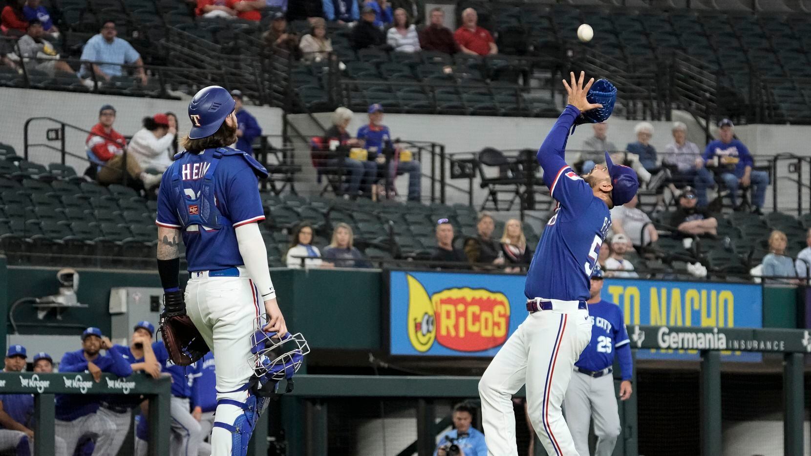 Texas Rangers starting pitcher Martin Perez (54) catches a fly ball in the infield during...
