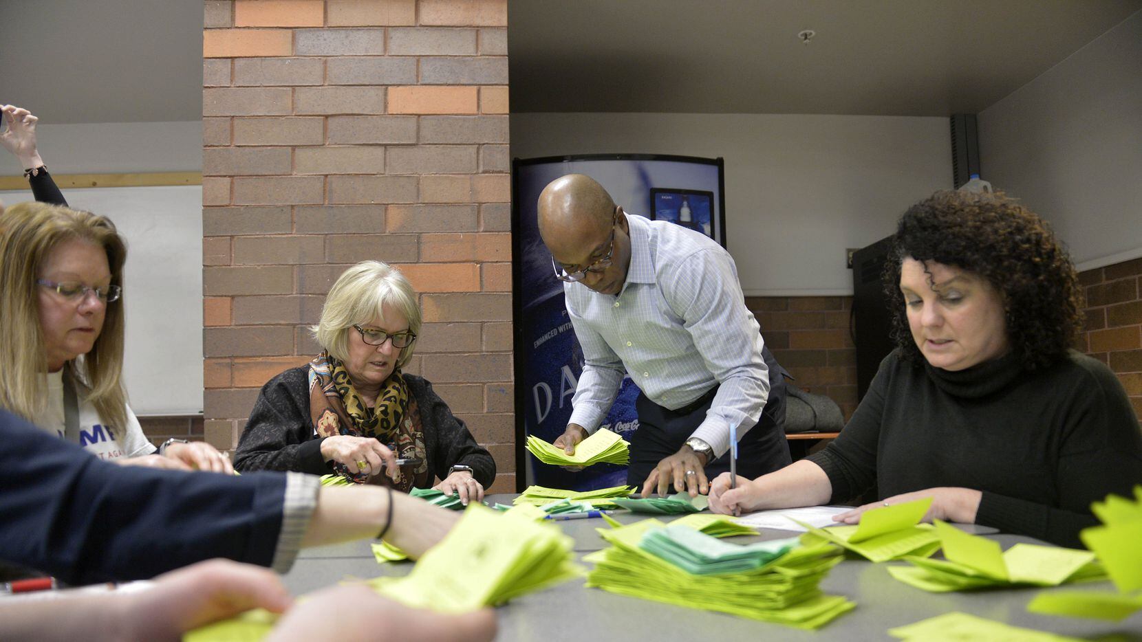 Staff members count ballots at a caucus site in Des Moines, Iowa, on Monday, Feb. 1, 2016....