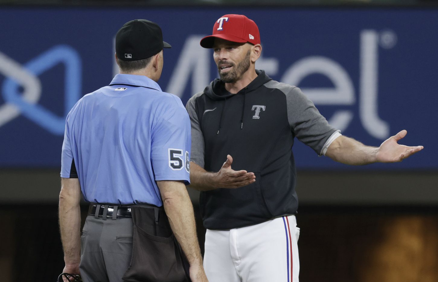 Texas Rangers manager Chris Woodward argues a call with home plate umpire Dan Iassogna...