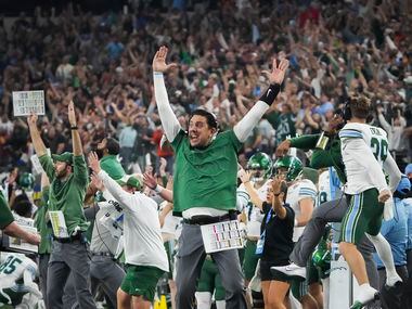 The Tulane bench erupts after tight end Alex Bauman scored on a 6-yard touchdown pass with...