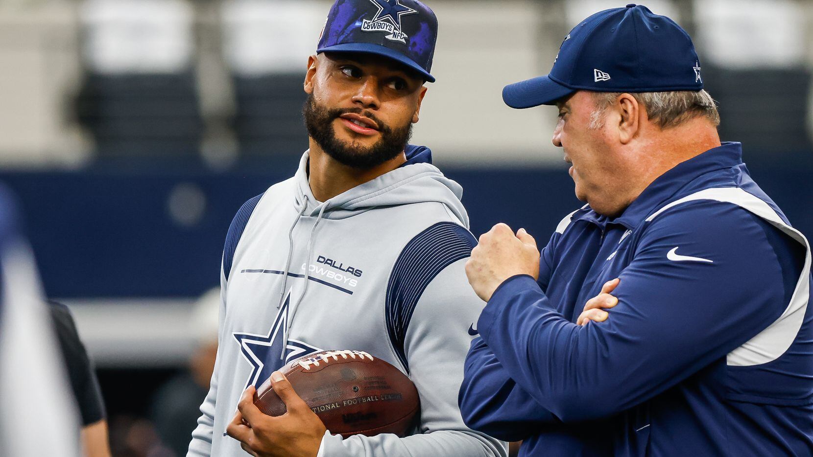 Dallas Cowboys quarterback Dak Prescott (4) talks with head coach Mike McCarthy during...
