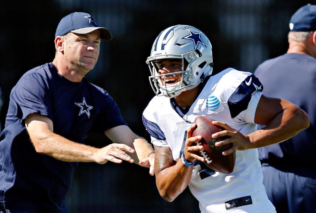 Dallas Cowboys quarterback Dak Prescott (4) runs a drill with offensive coordinator Scott...