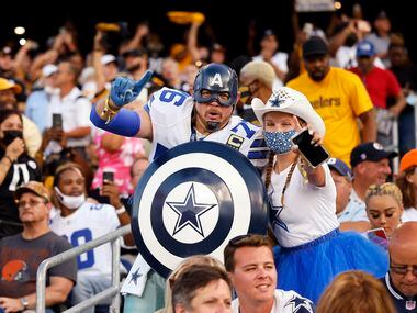 A pair of Dallas Cowboys fans find themselves surrounded by Pittsburgh Steelers fans before...