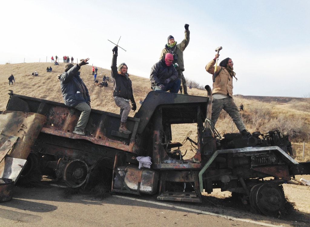 In this Monday, Nov. 21, 2016, file photo, protesters against the Dakota Access oil pipeline...