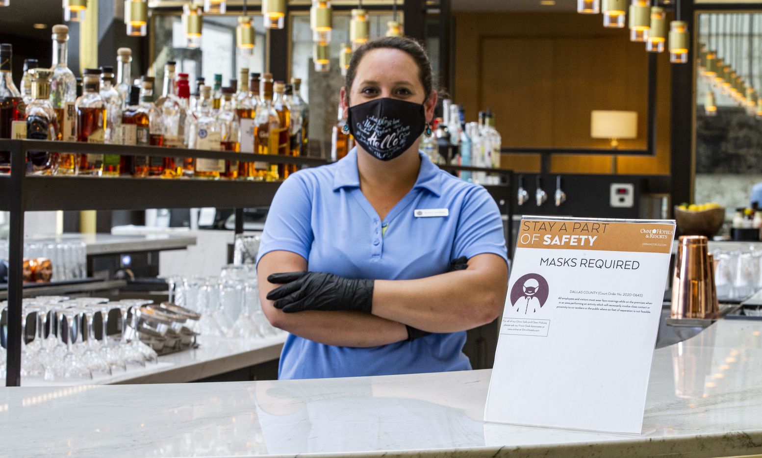 Food and Beverage Manager Brittany Sandidge wears a mask and gloves while working the main...