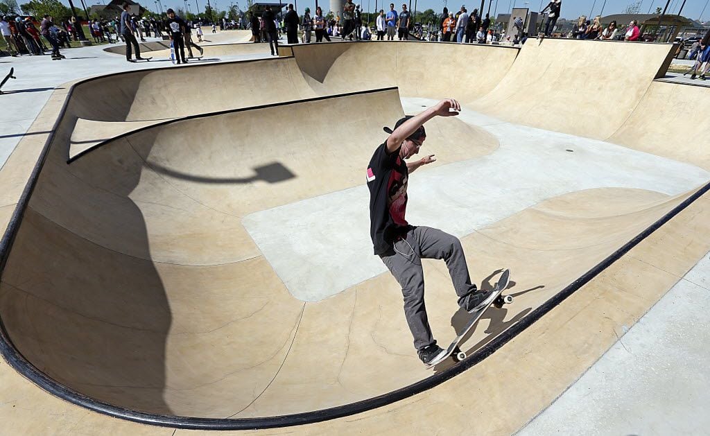 Jarod  Bookout, 16, of Azle practices on his skateboard at the new McKinney Skate Park grand...