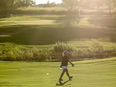 Amateur golfer Avery Zweig, 14, of McKinney walks the No. 8 fairway during the second round...