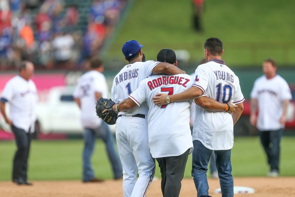 Texas Rangers shortstop Elvis Andrus (1) walks along with former catcher Ivan "Pudge"...