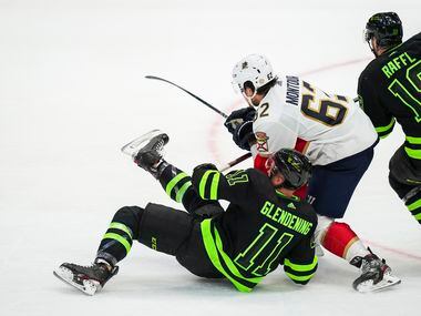 Dallas Stars center Luke Glendening (11) is knocked to the ice by Florida Panthers...