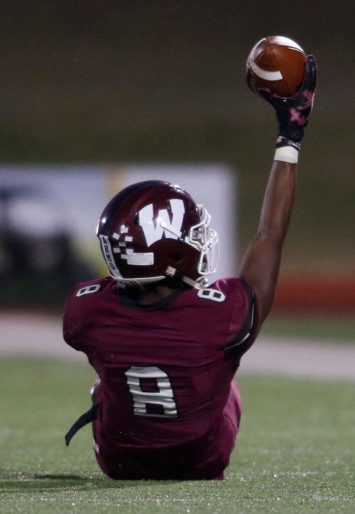 Wylie receiver Aaron Henry (8) displays the ball after pulling in a contested pass during...