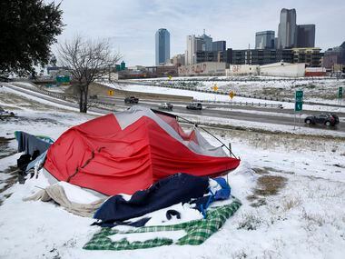 Snow-covered tents pitched along Interstate 30 were abandoned by their owners as a snowstorm and sub-freezing temperatures rolled into downtown Dallas. A nearby warming shelter at the Kay Bailey Hutchison Convention Center was set up by OurCalling and was housing about 700 people who found refuge from the deadly cold temperatures.