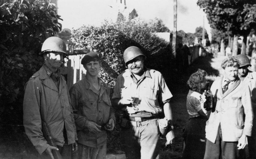 Ernest Hemingway and Col. David K.E. Bruce of the OSS, with a member of the French...