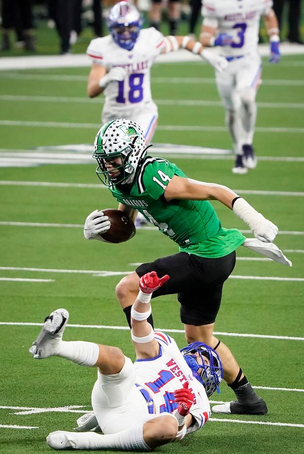 Southlake Carroll wide receiver Brady Boyd (14) break the tackles of Austin Westlake defensive back Michael Taaffe (14) on a 49-yard touchdown play during the first quarter of the Class 6A Division I state football championship game at AT&T Stadium on Saturday, Jan. 16, 2021, in Arlington, Texas. (Smiley N. Pool/The Dallas Morning News)