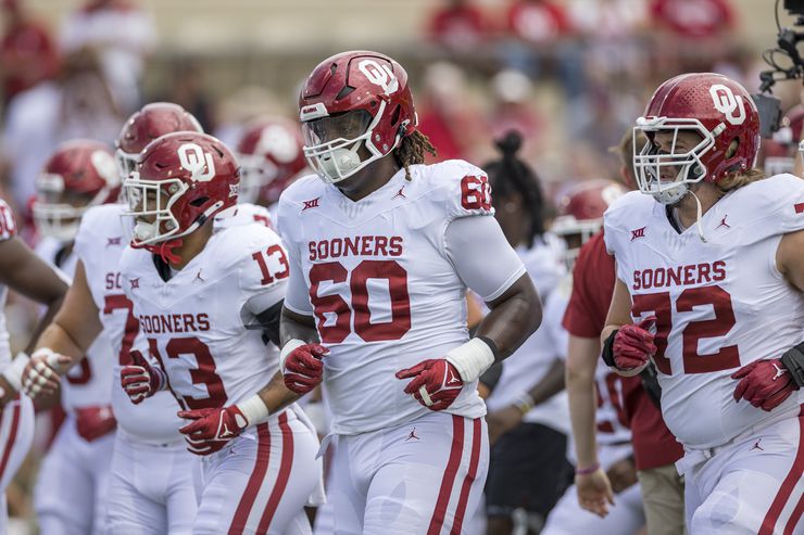 Oklahoma offensive lineman Tyler Guyton (60) warms up with his team before an NCAA college...