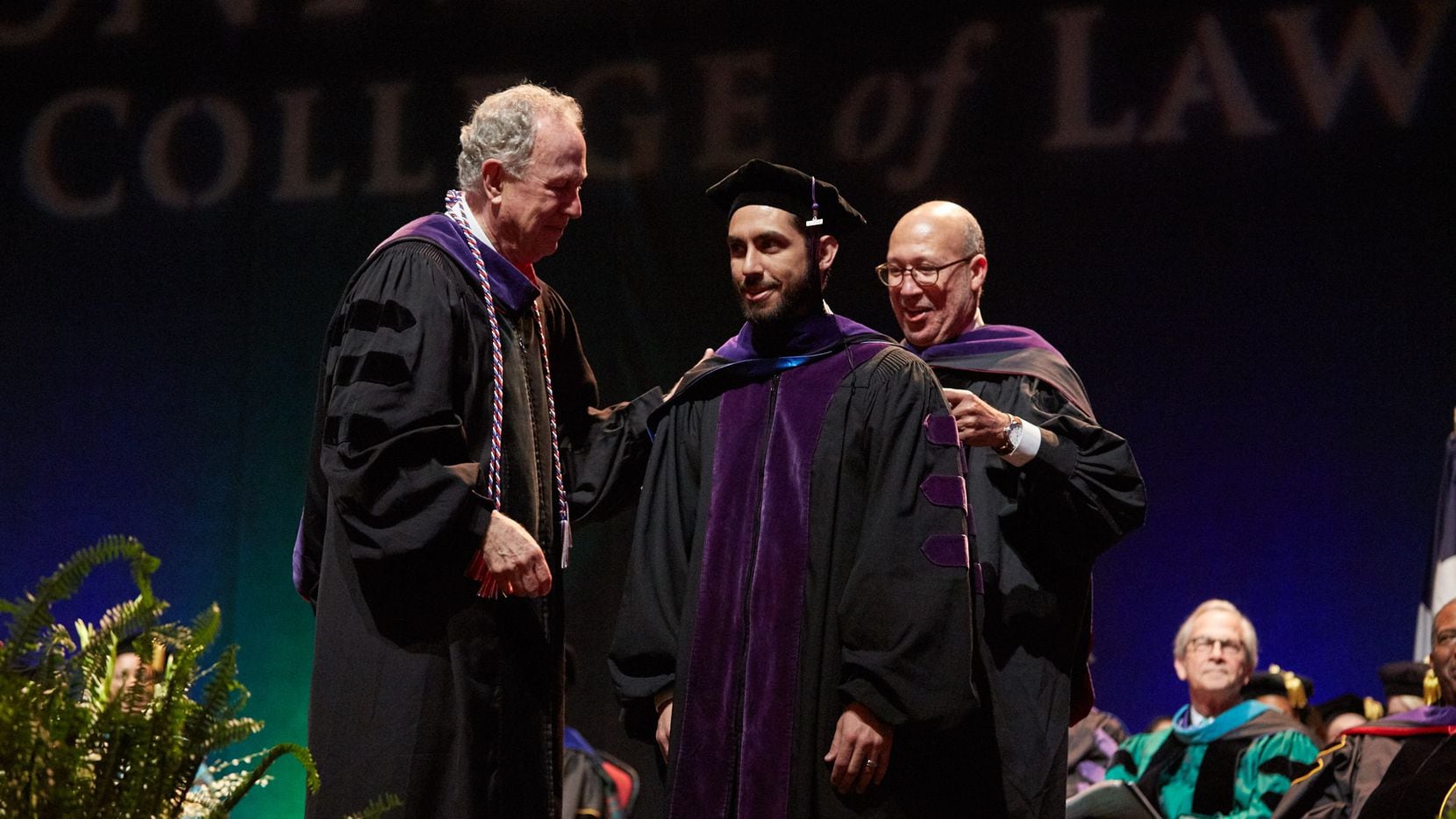 Law student Rafael Valbuena stands on stage during UNT Dallas' first Juris Doctor hooding...